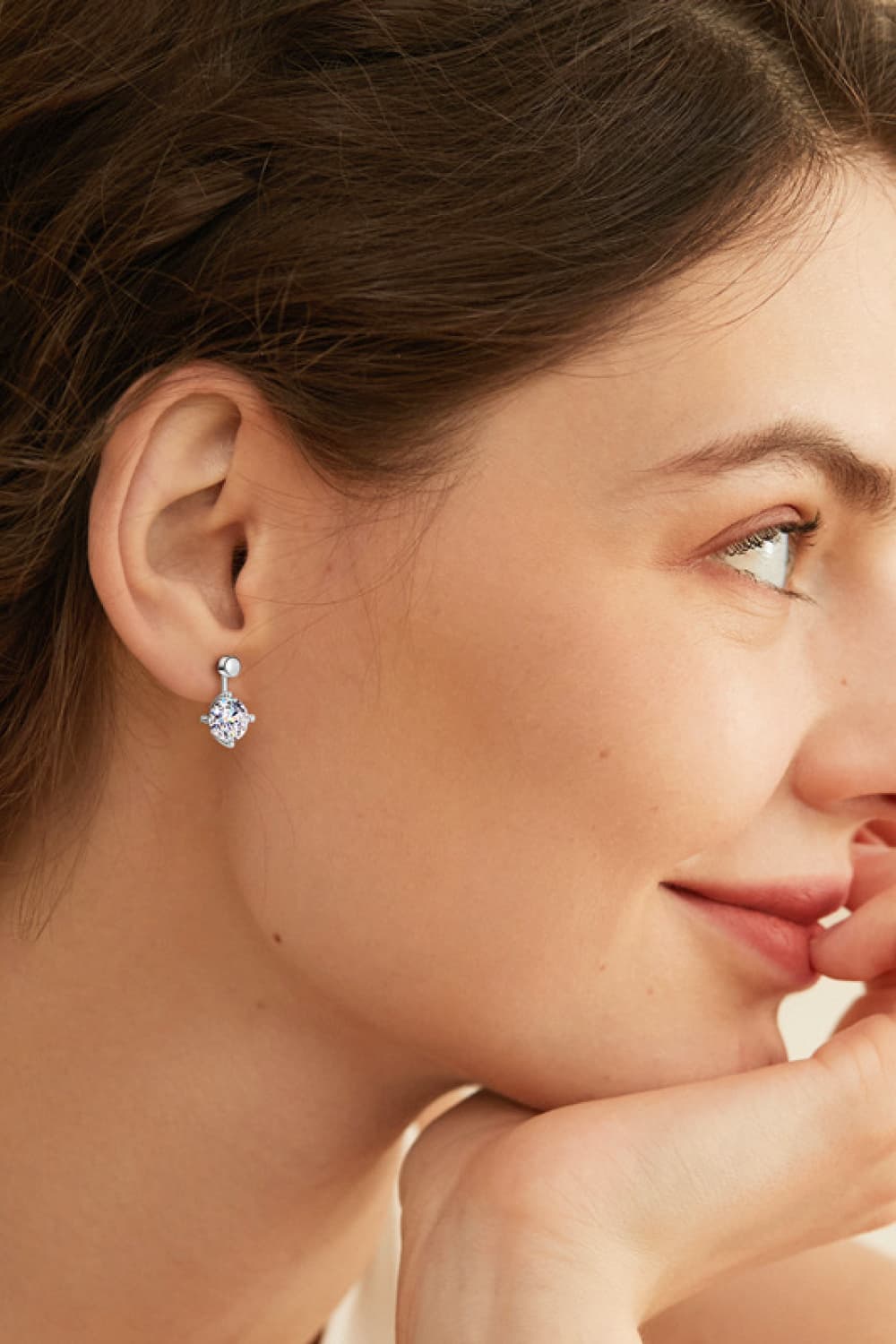 Silver moissanite stud and drop earrings with a round-cut center stone.