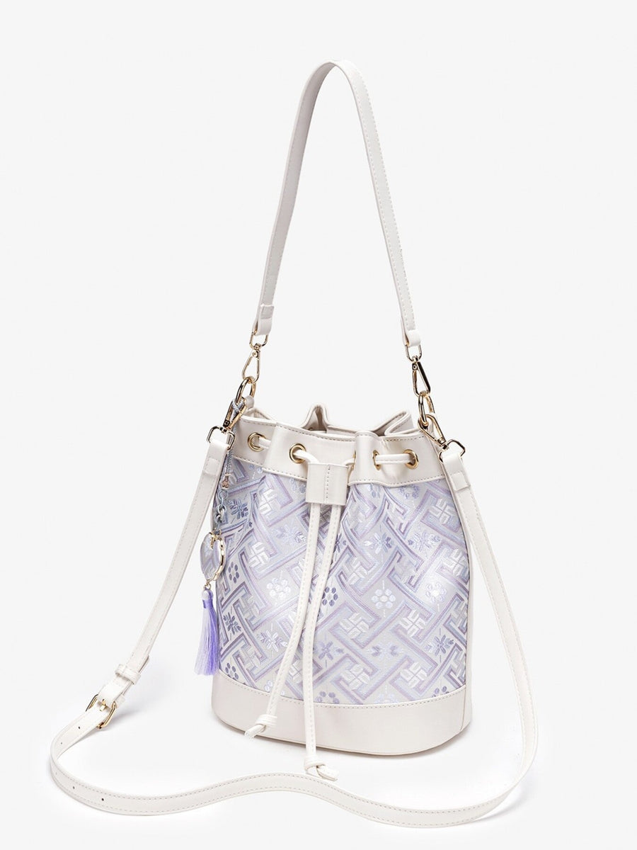 crossbody bag in light purple with geometric and drawstring closure