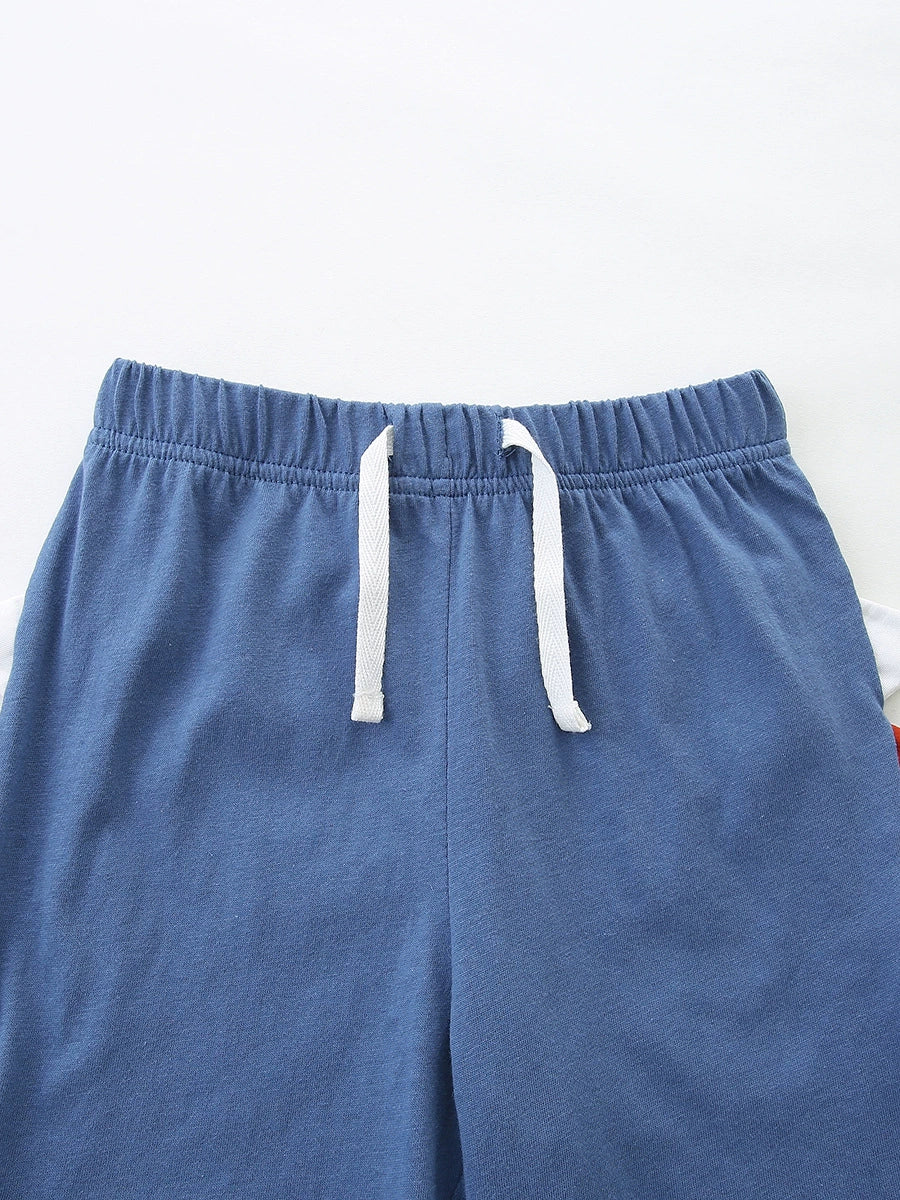 Baby blue cotton shorts with elastic waist and white drawstring detail.