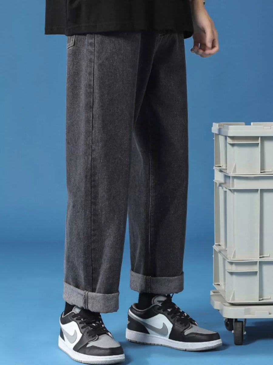 Men's relaxed fit cuffed hem jeans in black denim, shown with rolled cuffs.