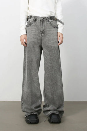 Wide-leg dark gray washed denim jeans with belt and relaxed fit.