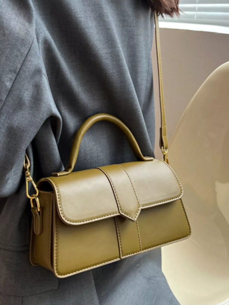 Chic small top handle shoulder bag in green with gold hardware and a flap closure.