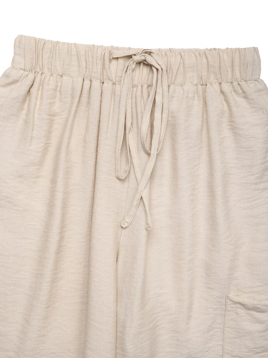 Chic waist-tie flare trousers in tan with a drawstring waist and textured fabric.