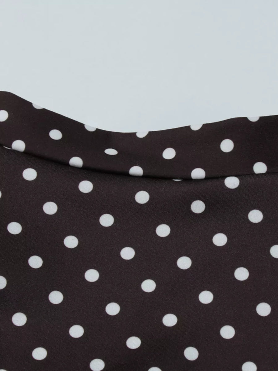 Brown polka dot mini dress with a cut-out detail and a curved neckline.