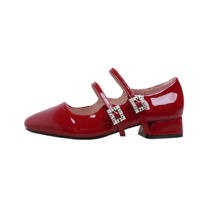 Patent leather double strap Mary Jane flats in scarlet with rhinestone buckles and a block heel.