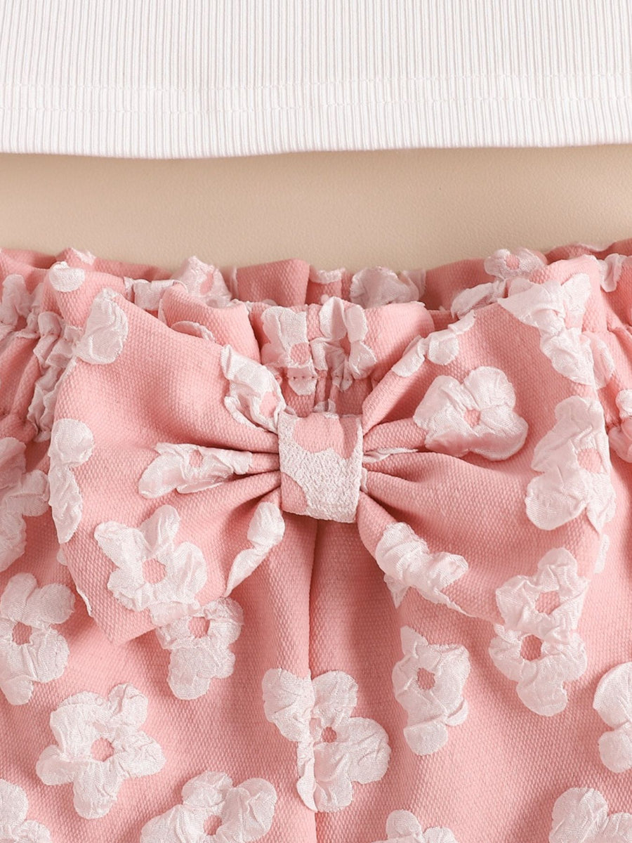 Pink ruffled shorts set with floral texture and bow detail