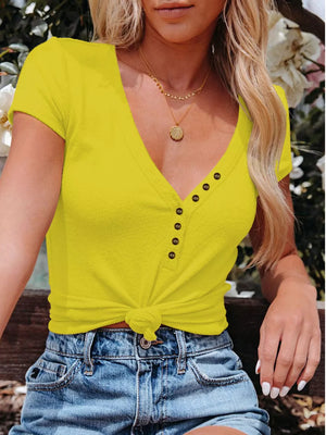 Yellow V-neck buttoned t-shirt with short sleeves and a knotted hem.