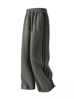 Men's grey sweatpants with black side stripes and drawstring waist