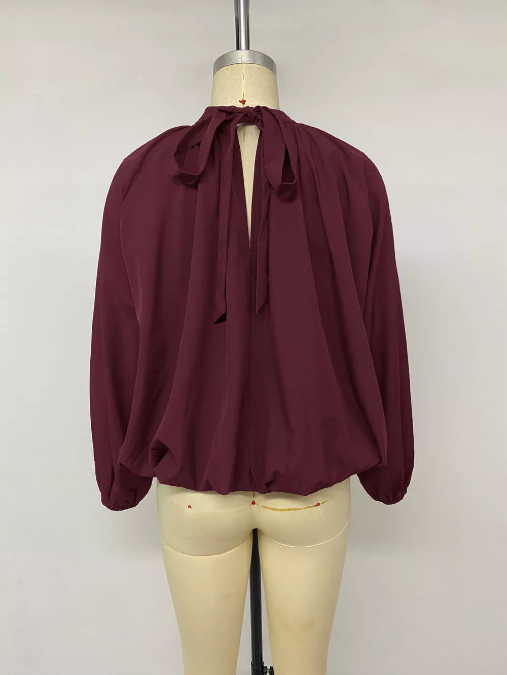 blouse in Fuchsia Pink with tied back and hip-length
