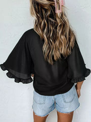 Black ruffled mock neck half sleeve shirt with sheer flutter sleeves.