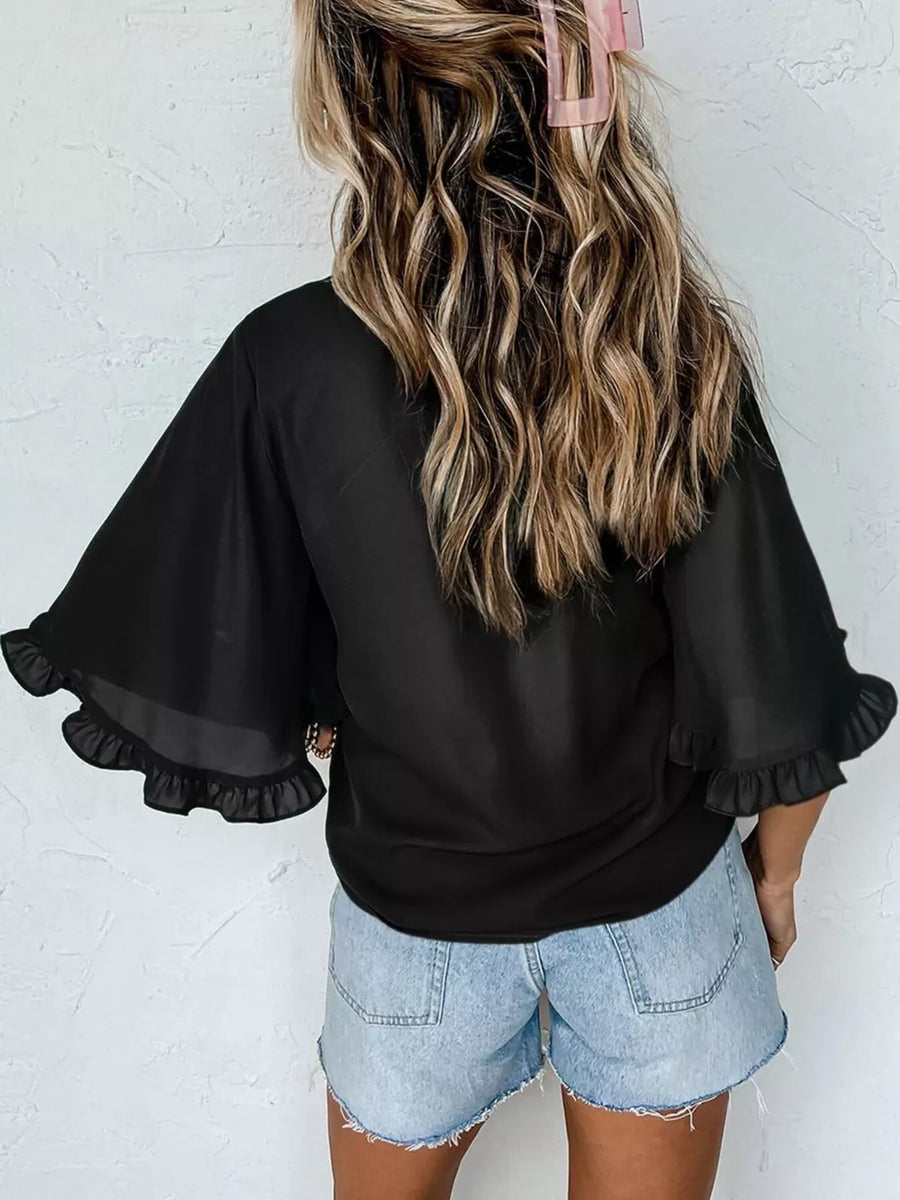 Black ruffled mock neck half sleeve shirt with sheer flutter sleeves.