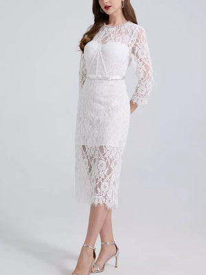 White lace midi dress with sheer sleeves, sweetheart neckline, and a satin belt.