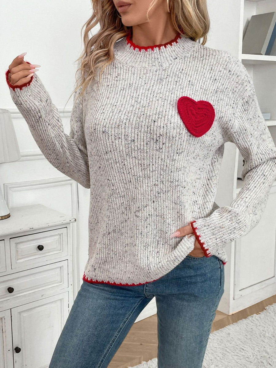 Light gray ribbed knit sweater with red heart appliqué and trim.