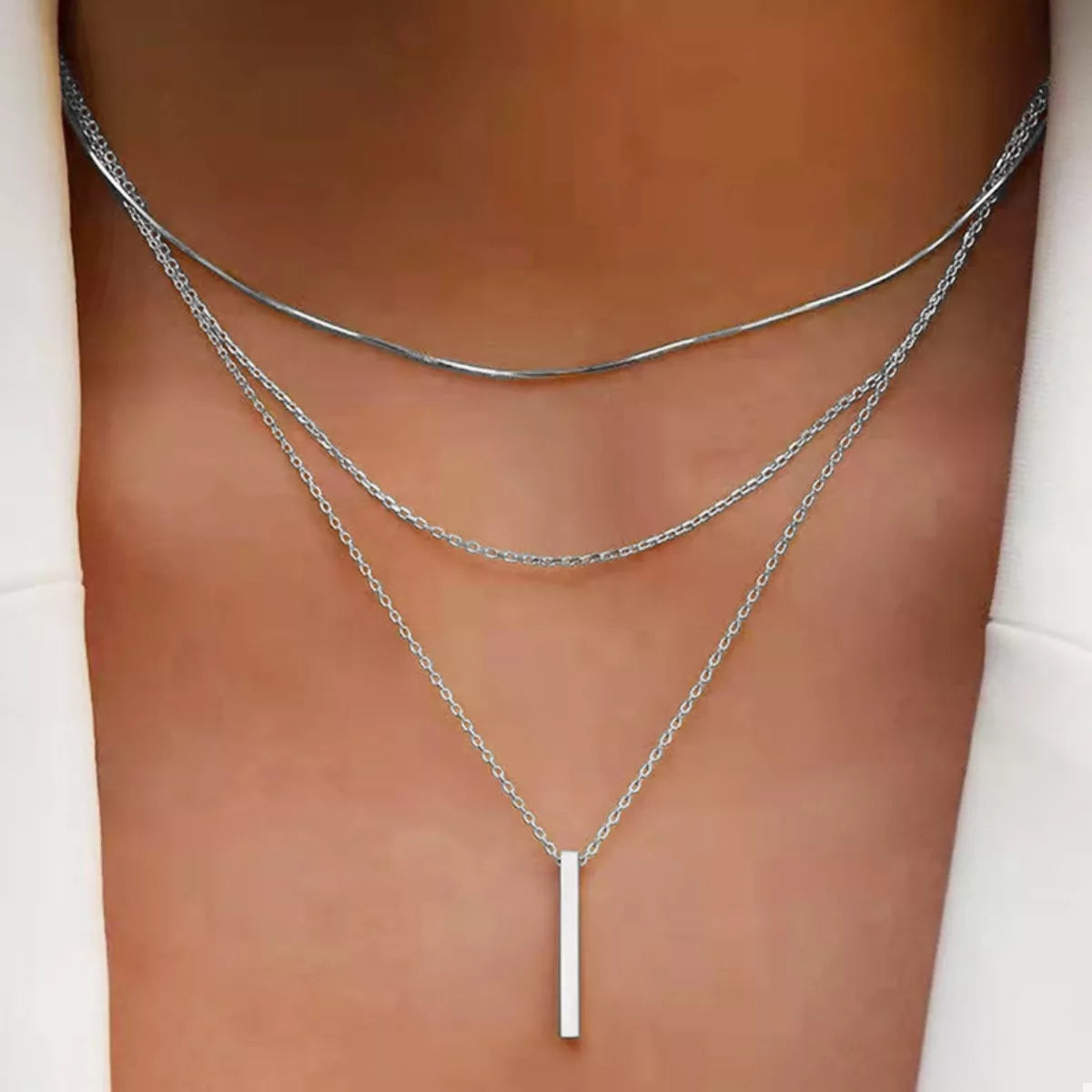 Silver layered bar pendant necklace with delicate chains.