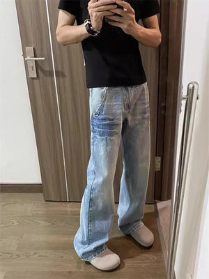 Distressed light wash denim wide leg jeans with chain detail for men.