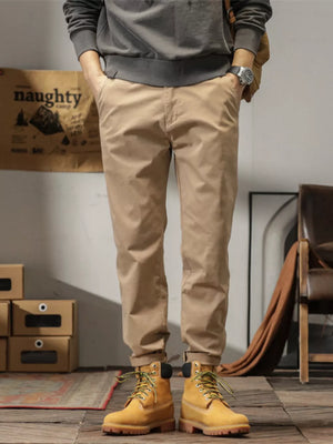 Men's plus size slim fit ankle pants in khaki, cuffed at the ankle.