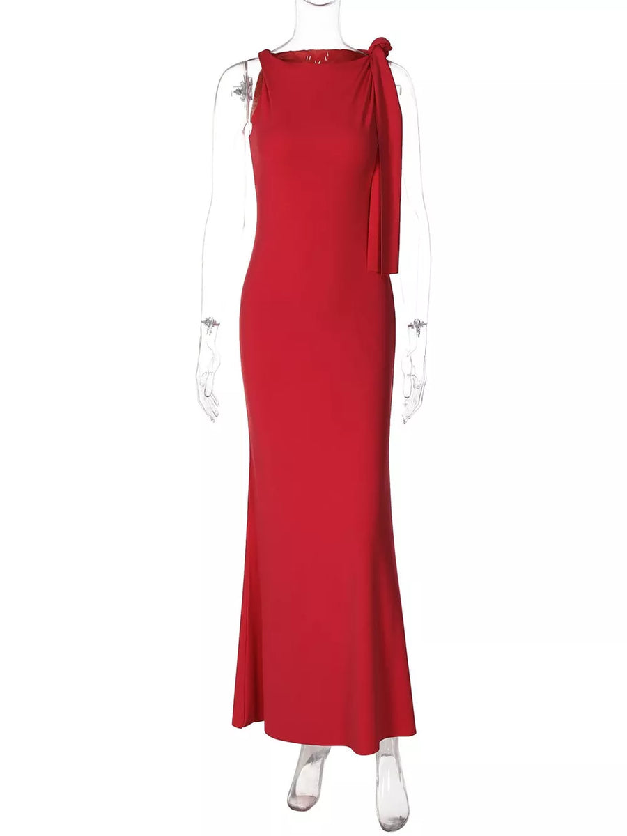 Red asymmetrical draped maxi dress with a bow detail on the shoulder.