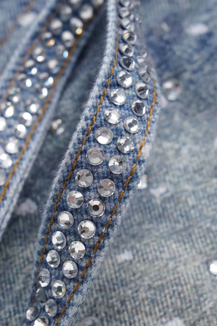 Medium wash denim jeans with ombré crystal embellishments on the seams.