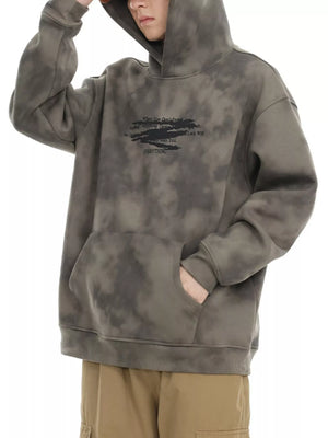 Oversized tie-dye hoodie in Cement Gray with graphic print and front pocket.