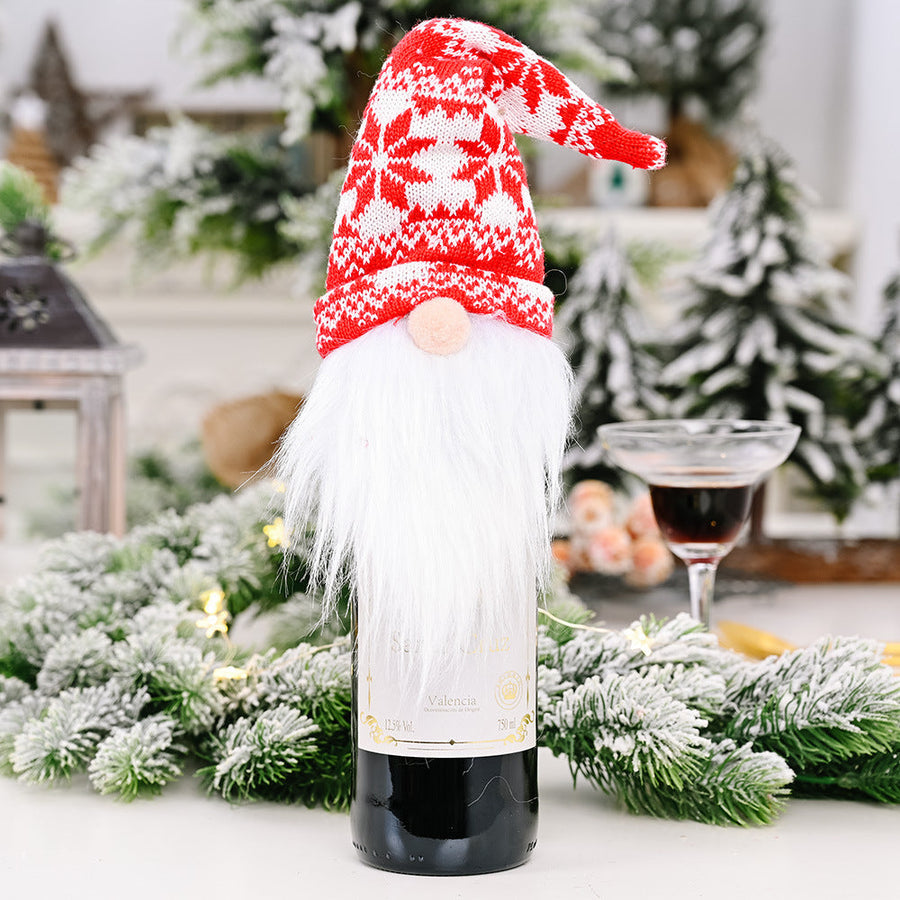 Festive gnome bottle topper with red and white snowflake hat and white beard.