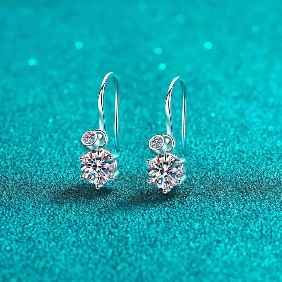 Silver drop earrings with a large solitaire gemstone and a smaller accent stone.