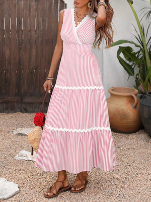 Lace-trimmed striped maxi dress in blush pink with a V-neck and tiered skirt.