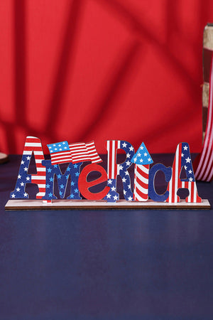 Patriotic wood block decor spelling AMERICA with American flag pattern and mini flags.