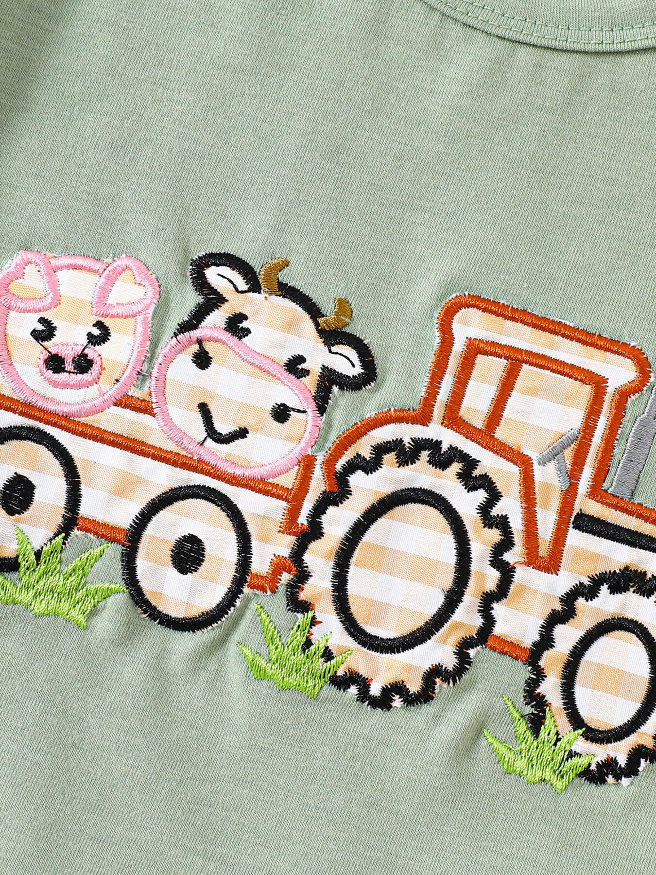 Light green baby tee with embroidered tractor, cow, and pig applique detail.