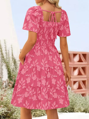 Smocked mini dress in Strawberry with floral embroidery, tiered skirt, puff sleeves, and tie-back square neck.