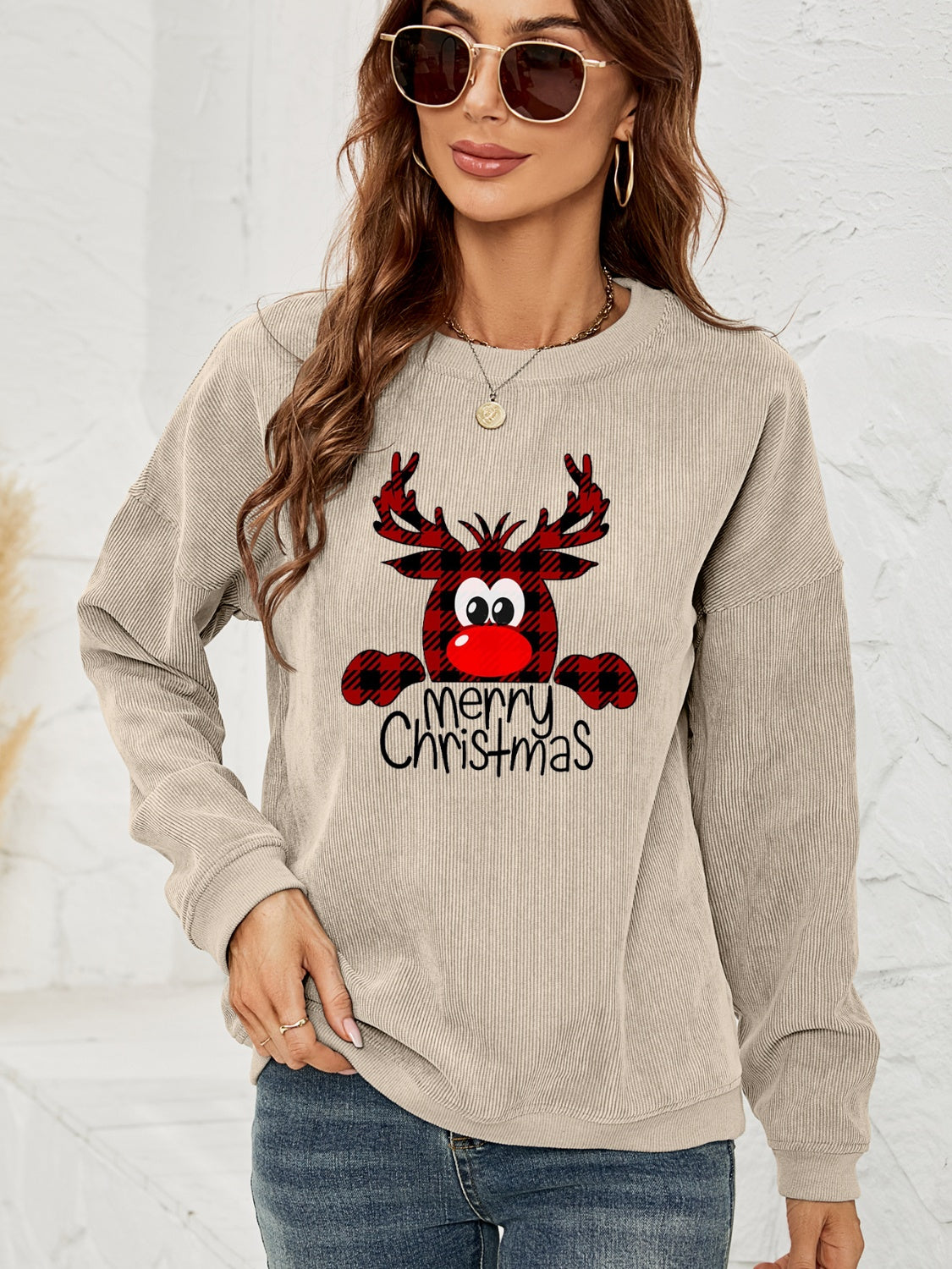 Beige corduroy sweatshirt with a festive reindeer graphic and "Merry Christmas" text.