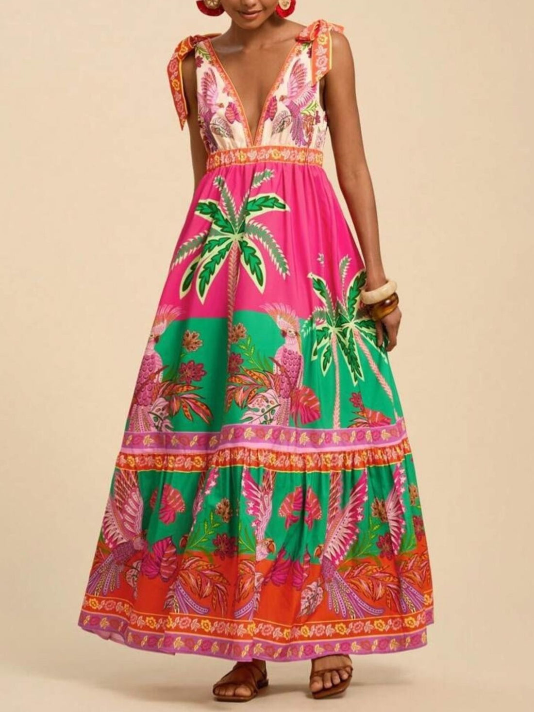 Tropical print maxi dress with tie shoulders, V-neck, and tiered skirt in pink, green, and orange.