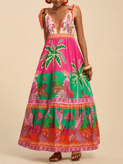 Tropical print maxi dress with tie shoulders, V-neck, and tiered skirt in pink, green, and orange.