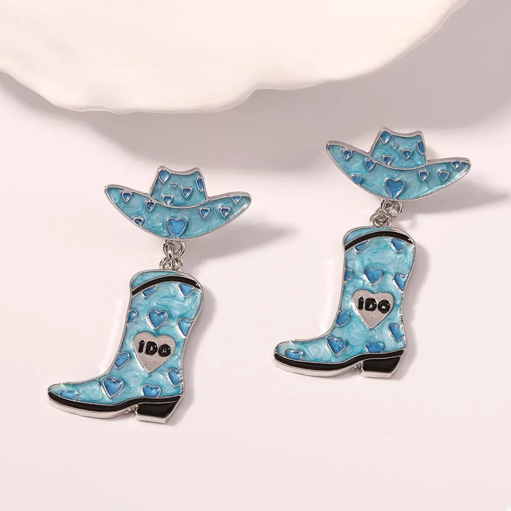 Sky blue cowgirl hat and boot dangle earrings with heart pattern and 18k gold accents.