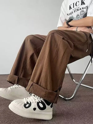 Brown relaxed fit cargo pants with cuffed hems and drawstring detail.