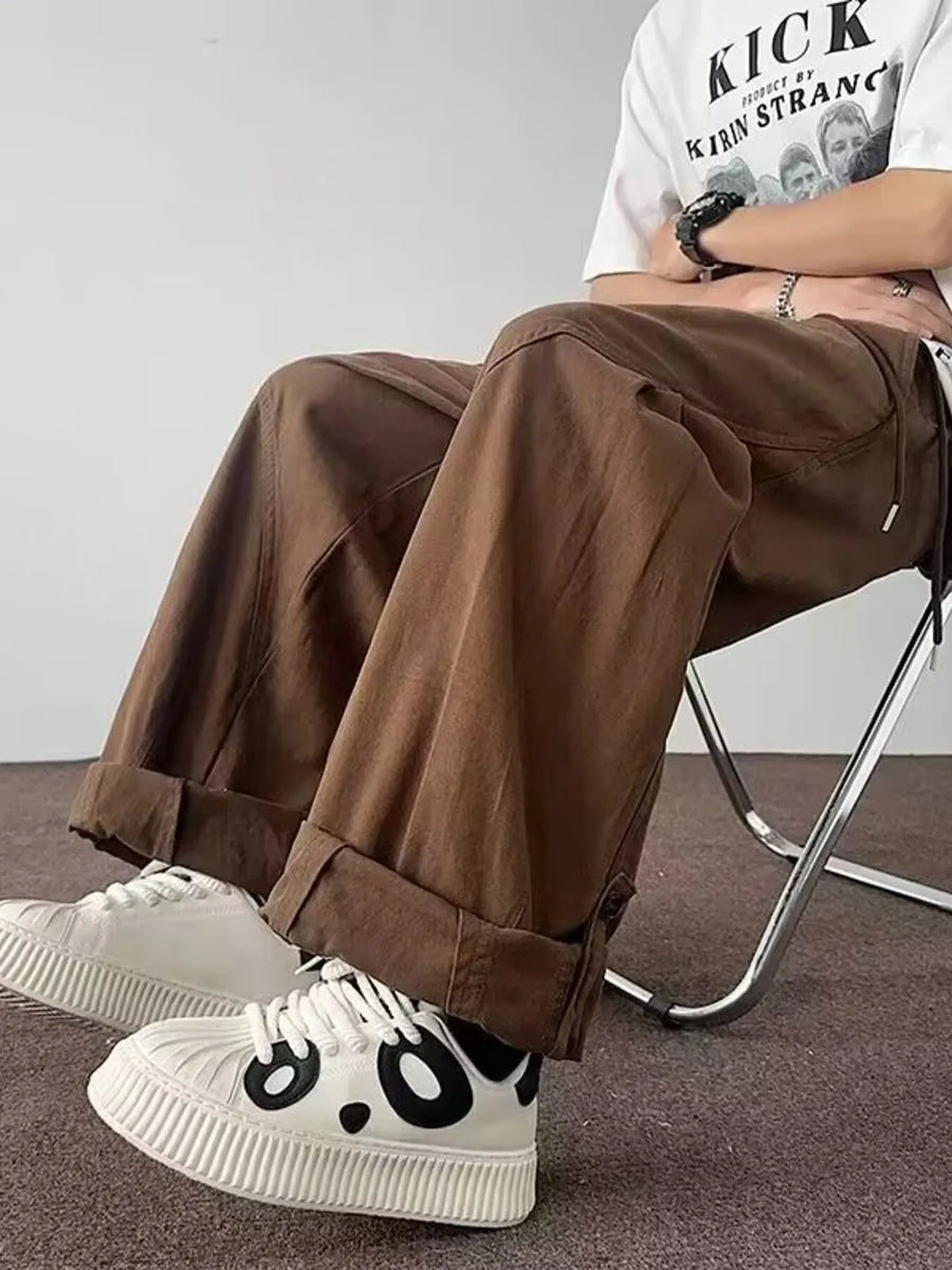 Brown relaxed fit cargo pants with cuffed hems and drawstring detail.
