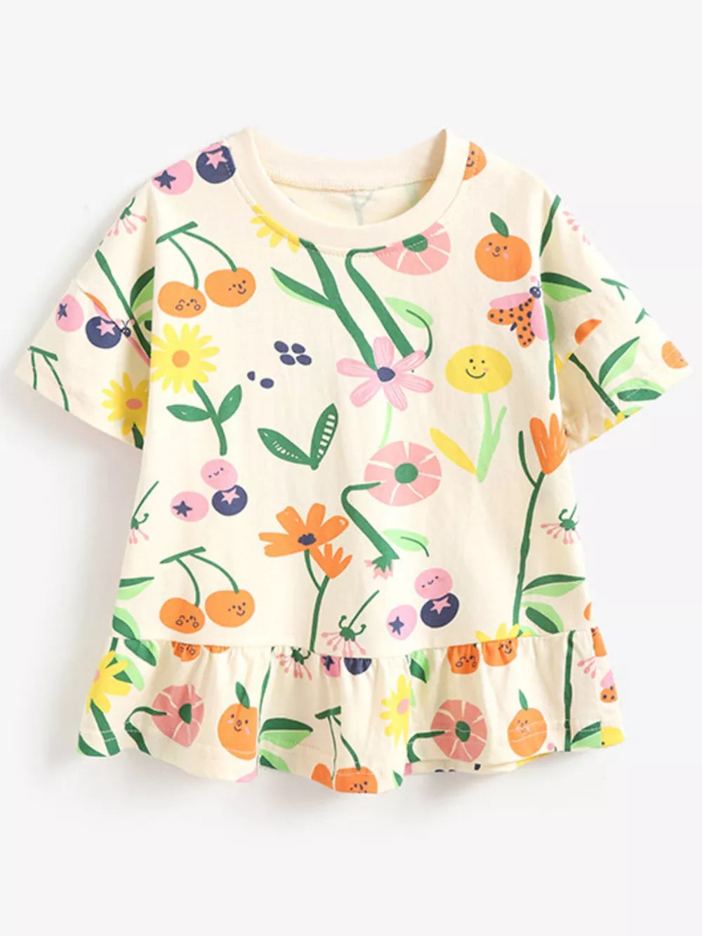 Cream cotton t-shirt with whimsical floral and fruit print and ruffled hem.