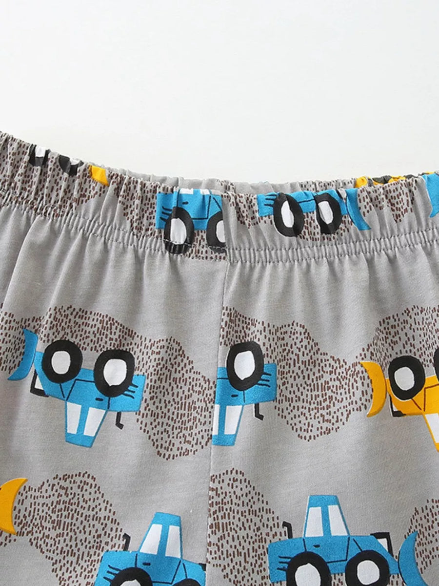 Toddler cotton blend shorts with blue construction vehicle print and elastic waistband.