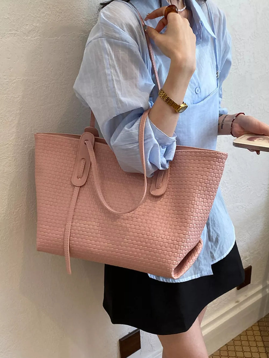 Pink tote featuring shoulder strap and woven texture