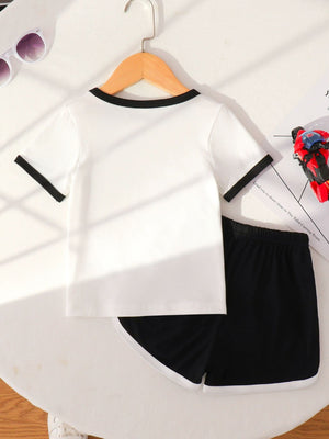 Baby white t-shirt with black trim and black shorts with white trim.