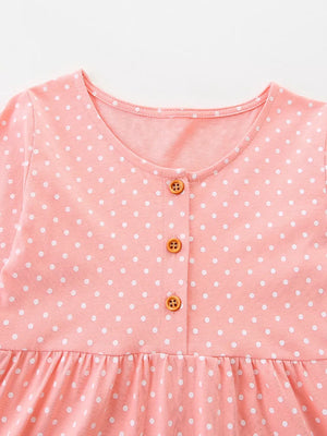 Pink polka dot cotton dress with round neck and button front.