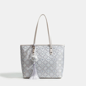 light grey tote featuring tassel charm and geometric