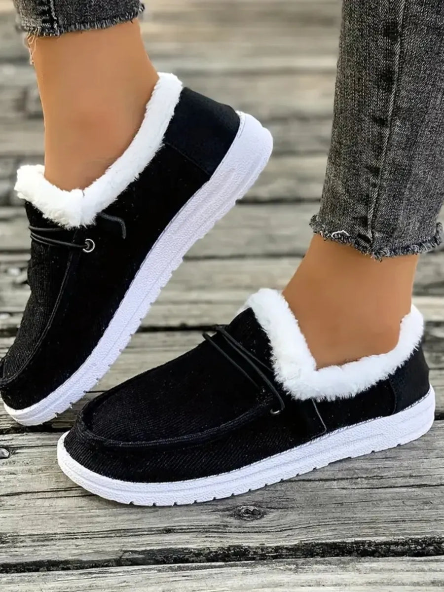 Black corduroy slip-on sneakers with white sherpa lining and white soles