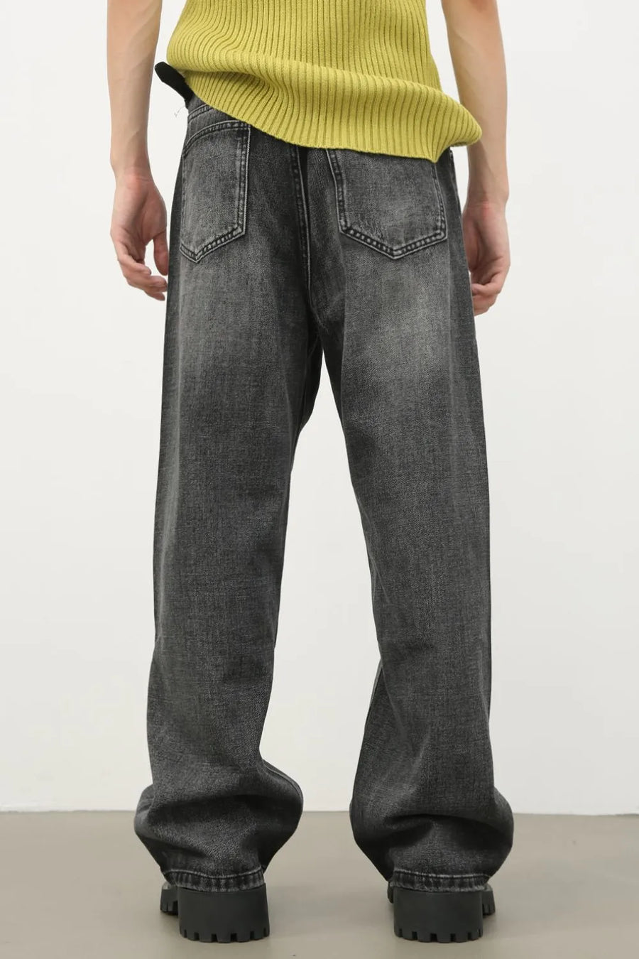 Baggy fit dark washed denim jeans with knee rips and a casual style.