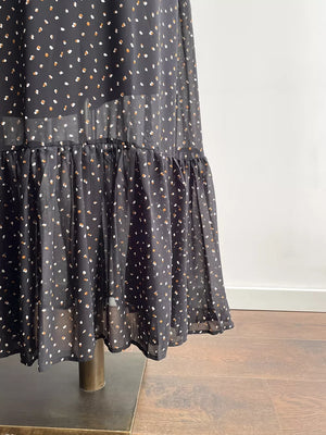 Black floral maxi dress with tiered ruffle hem and sheer overlay.