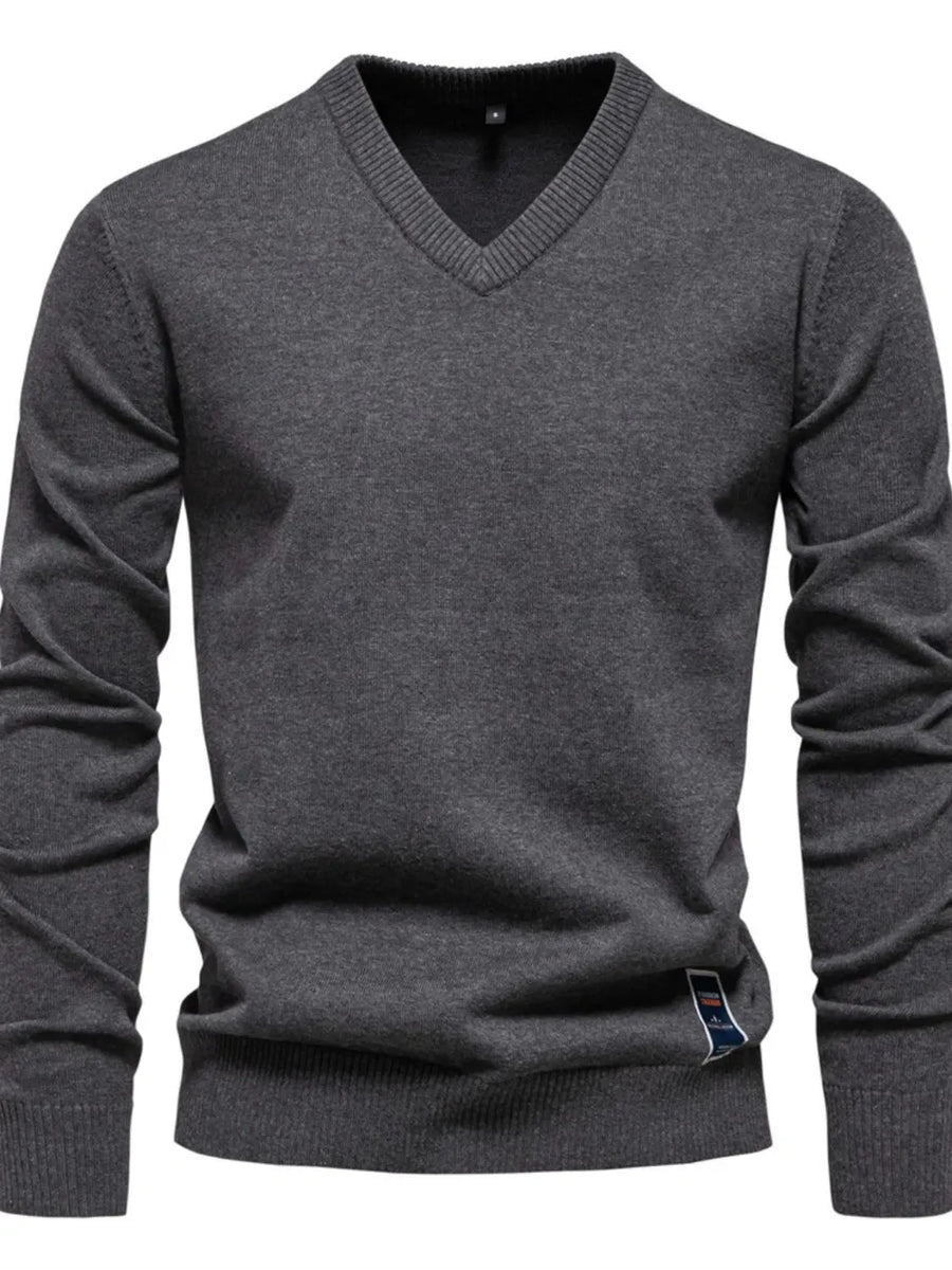 Dark Gray ribbed knit V-neck sweater with a small logo tag on the hem.