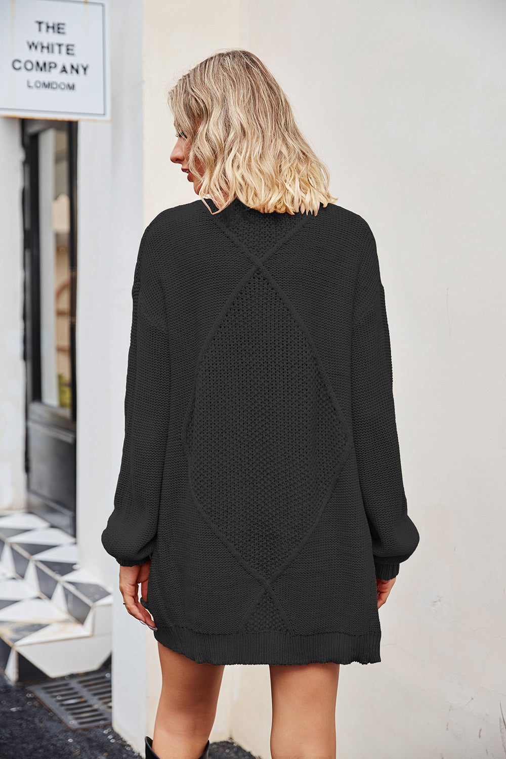 Black cable knit cardigan with diamond pattern detail on back, acrylic.