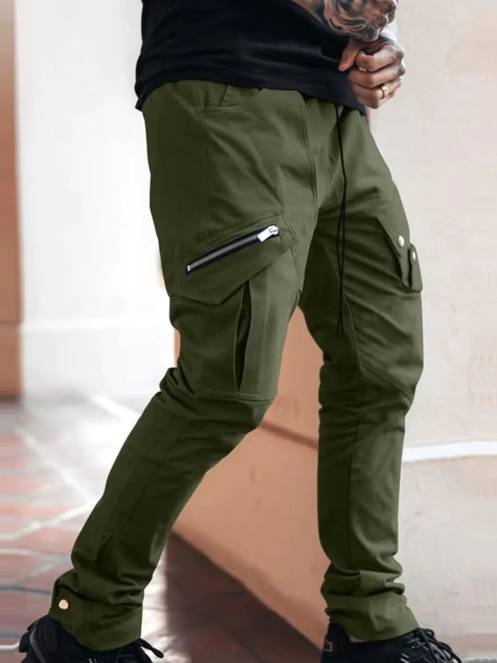 Army green slim cargo trousers with zip pockets and drawstring waist.