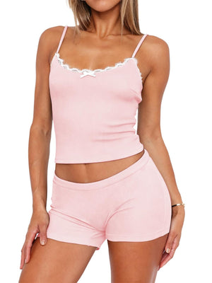 Blush pink cami and shorts set with white lace trim and a bow detail.