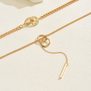 Gold layered Y-shaped pendant necklace with interlocking rings and bar drop.