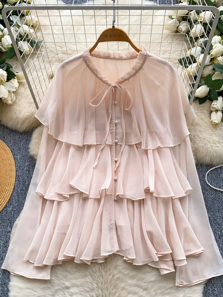 Pink chiffon blouse with tiered ruffles, bow tie neck, and button front.